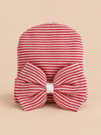 Cappellino da neonata in cotone a righe con grande fiocco, colori rosso e bianco, vista frontale