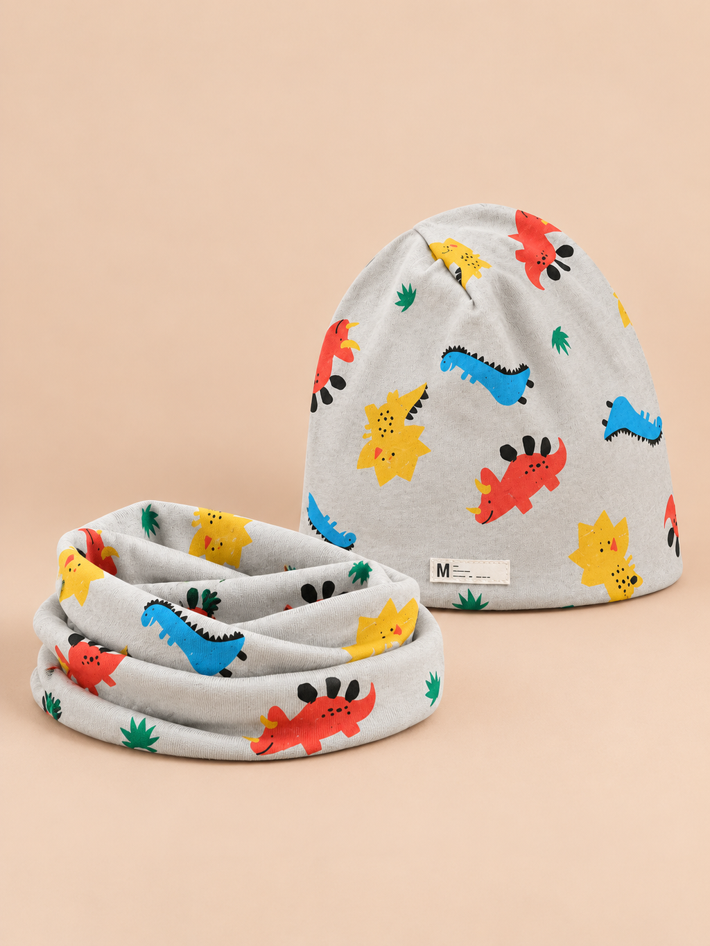 Set berretto e sciarpa da bambino con dinosauri, variante dinosauro verde mandorla, vista frontale