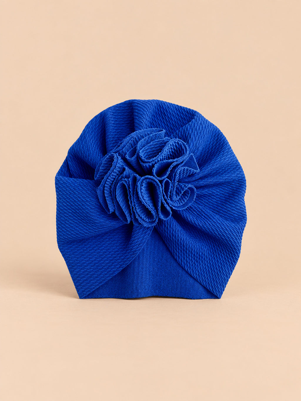 Turbante blu da neonato con fiore decorativo in tessuto sul davanti e forma morbida, vista frontale