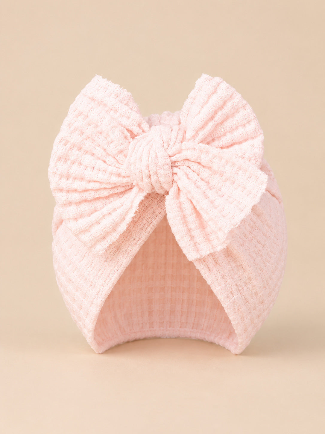 Turbante da neonata con fiocco in cotone lavorato a maglia, colore rosa chiaro, vista frontale