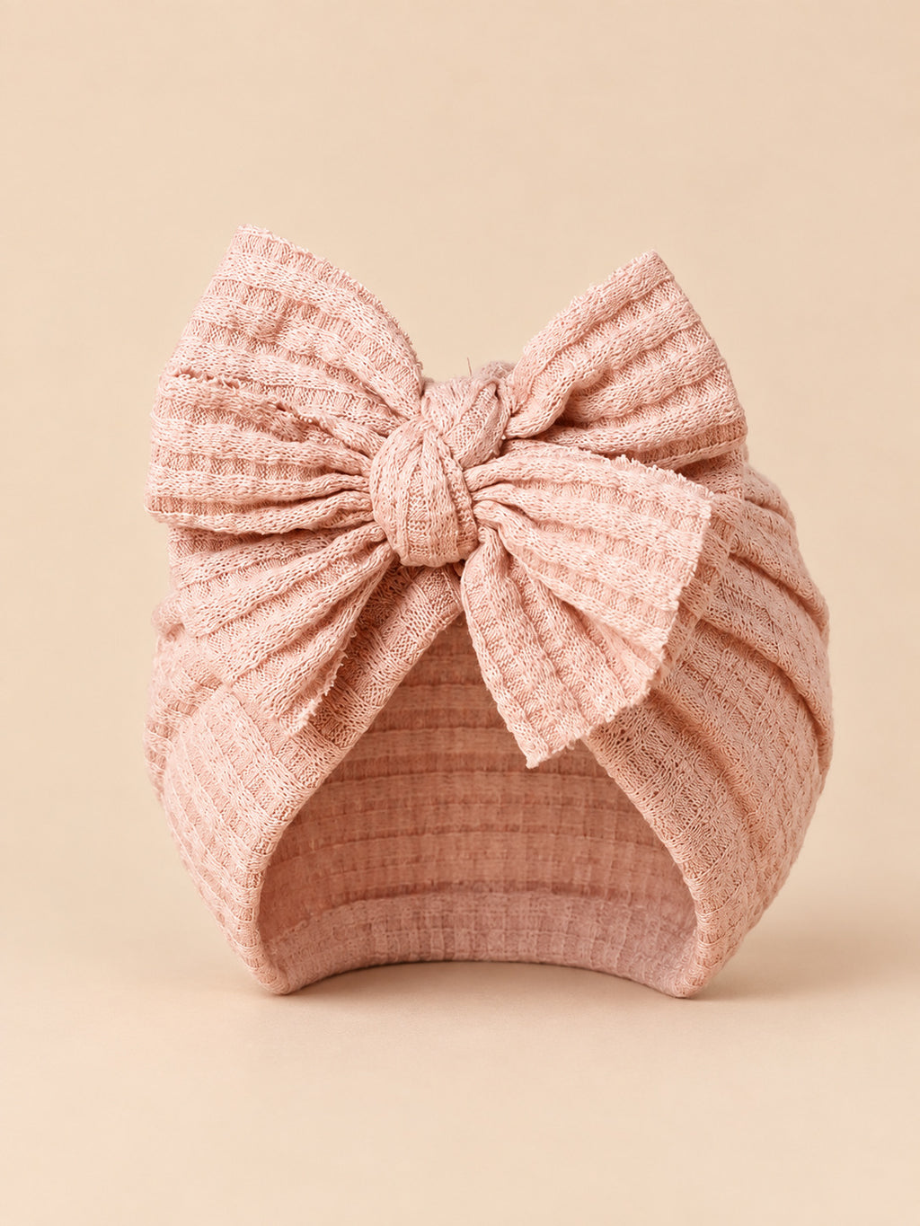 Turbante da neonata con fiocco in cotone lavorato a maglia, colore rosa cipria, vista frontale