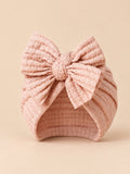 Turbante da neonata con fiocco in cotone lavorato a maglia, colore rosa cipria, vista frontale